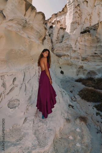 woman in a pink dress on the beach in milos greece model shooting 