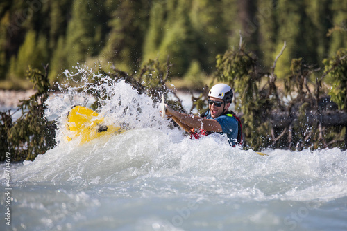 Paddler is engulfed by large rapids, wave. photo