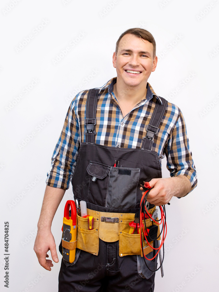 Happy technician in uniform over white background. Electrician with standard equipment Happy technician in uniform over white background. Electrician with standard equipment