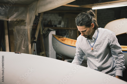 Canoe builder at a small wood workshop, self organised production photo