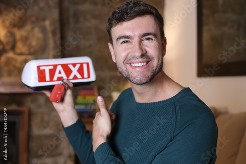Excited taxi driver with car keys and illuminated sign
  photo