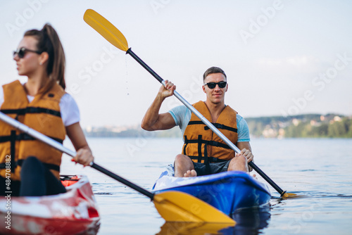 Couple together kayaking on the river