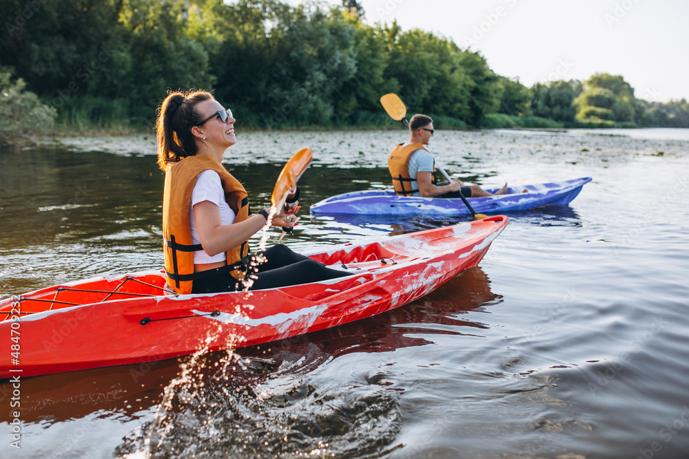 Couple together kayaking on the river - obrazy, fototapety, plakaty 