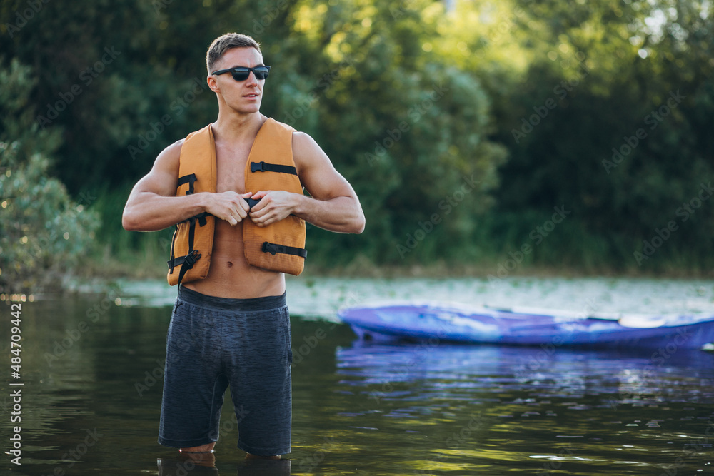 Young man kayaking on the river