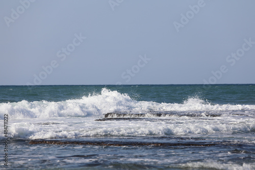 The big breaking waves during a strom at the beautiful summer sea shore background the blue sky and horizon. High quality photo photo