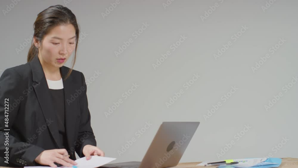 Medium Shot of Businesswoman Working at Desk Medium Shot of Businesswoman Working at Desk