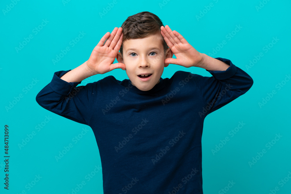 Little kid boy isolated on blue background with surprise expression Little kid boy isolated on blue background with surprise expression