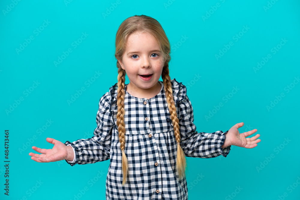Little caucasian girl isolated on blue background with shocked facial expression Little caucasian girl isolated on blue background with shocked facial expression