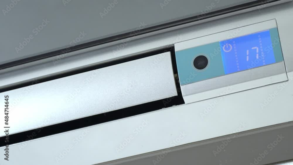 Turning on and off the operation of the air conditioner. Rotation of the impeller of the outdoor unit. The LCD display with the inscription cooling turns on and is illuminated with neon or blue glow. Turning on and off the operation of the air conditioner. Rotation of the impeller of the outdoor unit. The LCD display with the inscription cooling turns on and is illuminated with neon or blue glow.