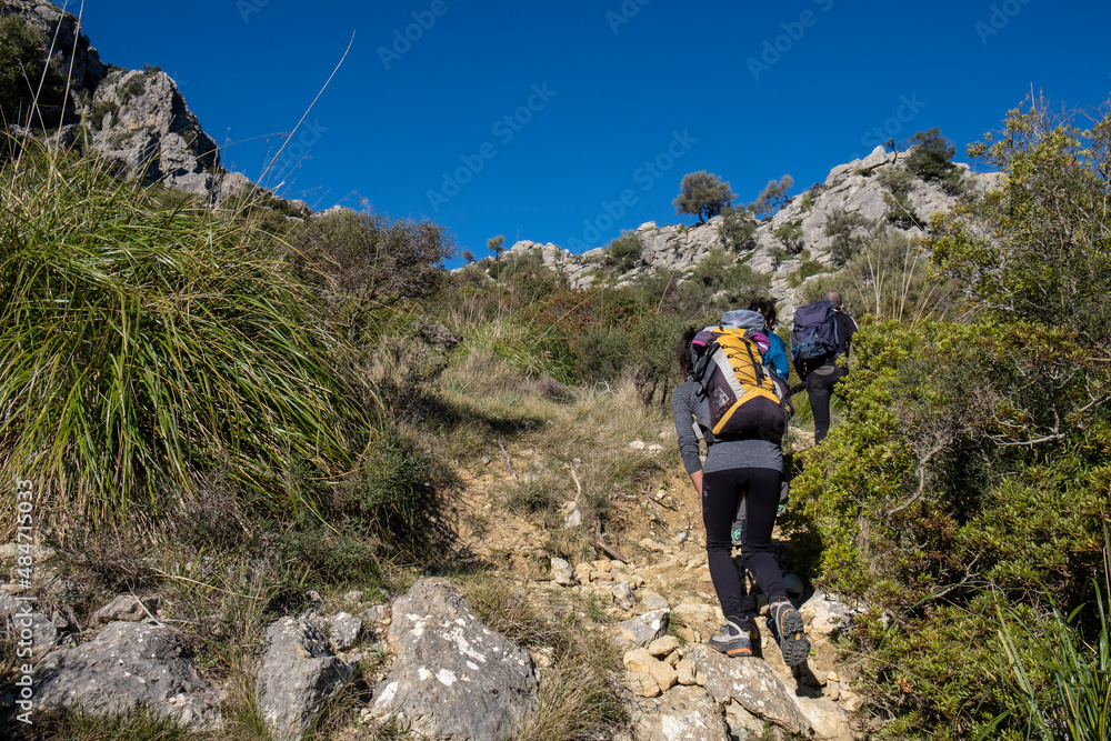 Fototapeta premium hikers ascending Cucuia de Fartaritx, Assarell , Pollença, Mallorca, Balearic Islands, Spain
