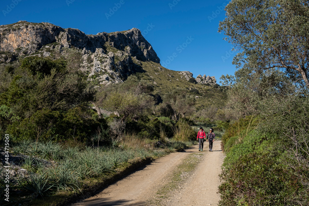 two hikers walking along the Assarell path, Pollença, Mallorca, Balearic Islands, Spain two hikers walking along the Assarell path, Pollença, Mallorca, Balearic Islands, Spain
