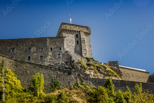 Castle on the hill. Architecture of old Europe. An impregnable fortress on a hill. Bottom view of the stone building. House against the sky.