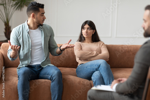 Couple talking at therapy session with male therapist