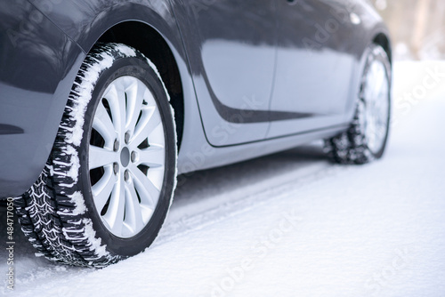 Car on the Winter Road. Close-up Image of Winter Car Tire on the Snowy Road. Safe Driving Concept. © Maksym Protsenko