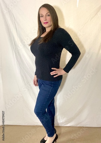 plus size curve curvy women model in top and skinny jeans against white background  photo