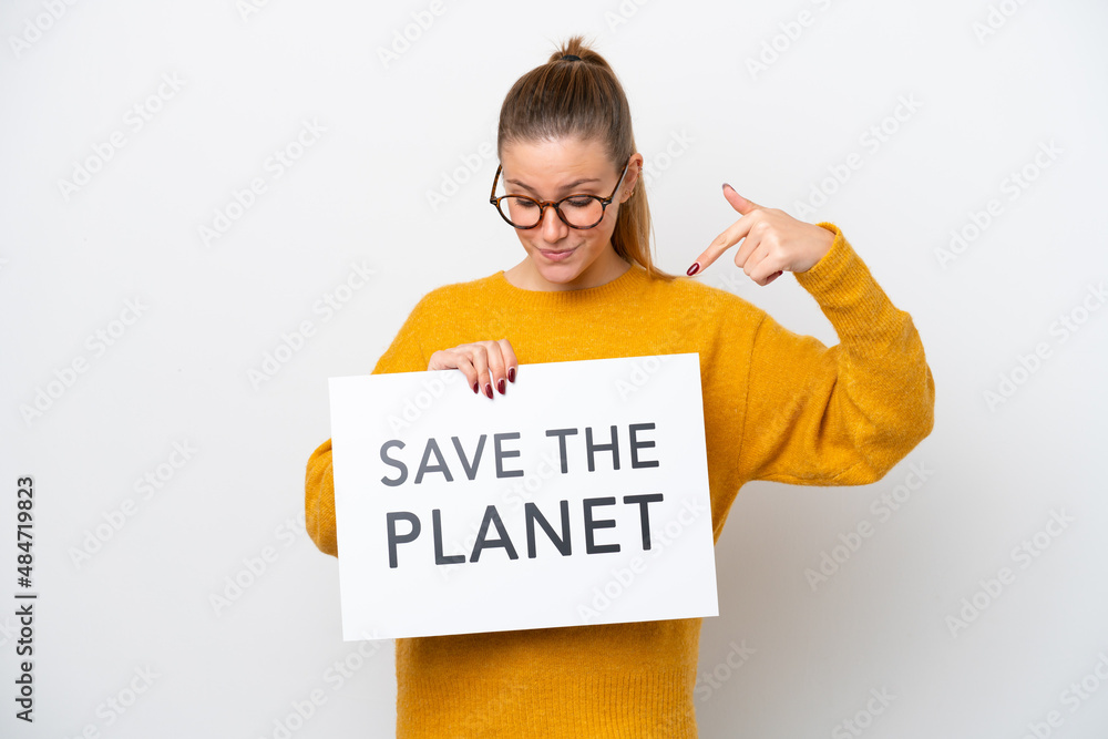 Young caucasian woman isolated on white background holding a placard with text Save the Planet and pointing it Young caucasian woman isolated on white background holding a placard with text Save the Planet and pointing it