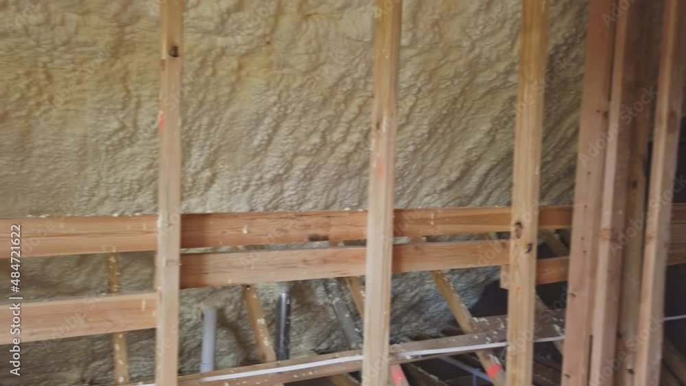 New home construction with installation of attic with foam insulation the roof New home construction with installation of attic with foam insulation the roof