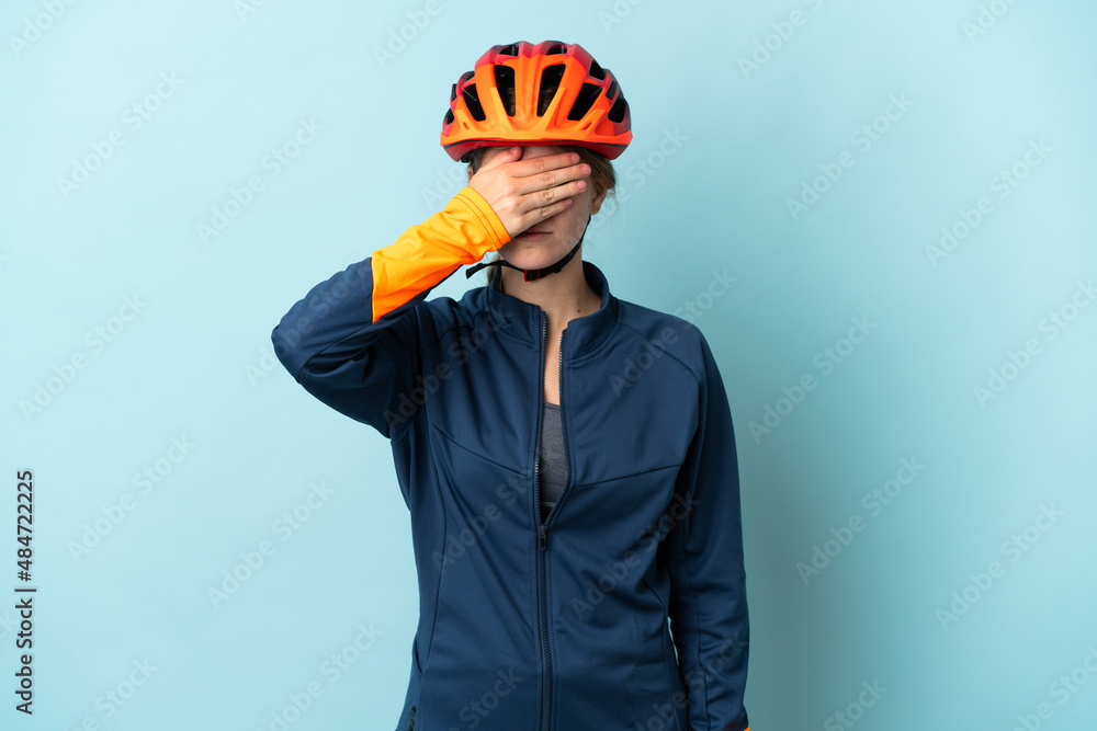 Young cyclist woman isolated on blue background covering eyes by hands. Do not want to see something Young cyclist woman isolated on blue background covering eyes by hands. Do not want to see something