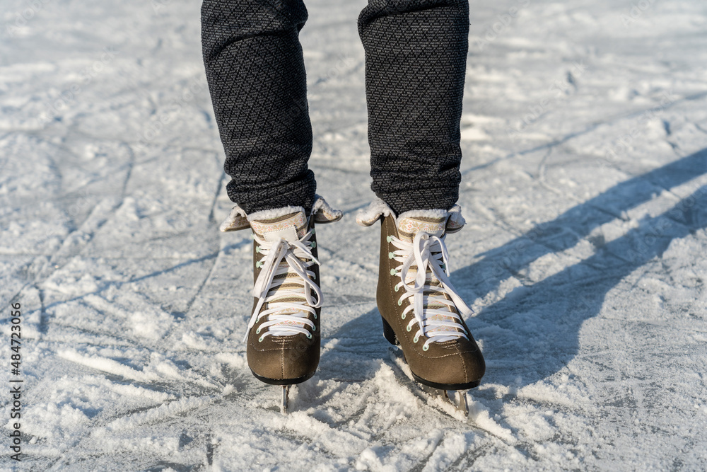 Women's figure skates on ice with a little bit snow Women's figure skates on ice with a little bit snow
