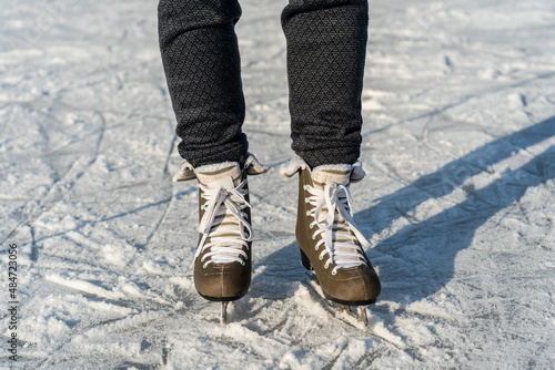Women's figure skates on ice with a little bit snow