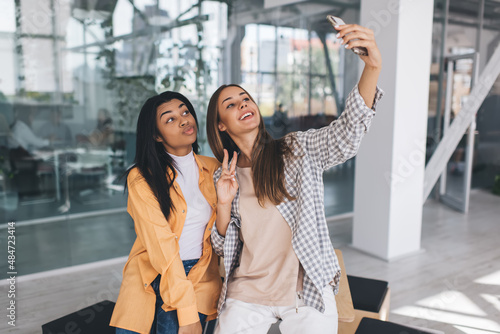 Smiling girlfriends taking selfie on mobile phone © BullRun