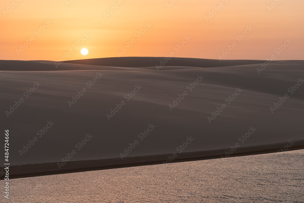 Beautiful sunset view to rainwater lagoon on sand dunes
