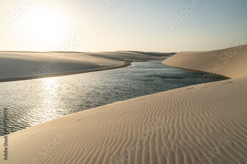Beautiful view to blue rainwater lagoon on white sand dunes photo
