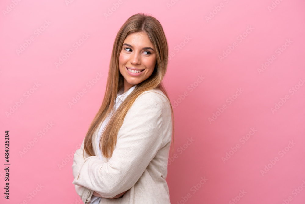 Young caucasian woman isolated on pink bakcground looking to the side and smiling Young caucasian woman isolated on pink bakcground looking to the side and smiling