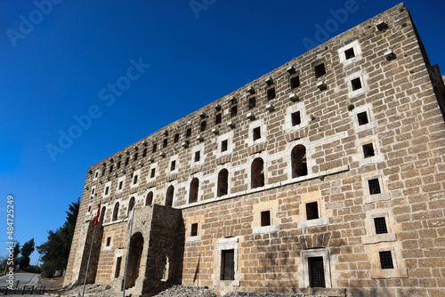 facade of majestic and well preserved Roman theatre in ancient city Aspendos, Turkey under blue spring sky