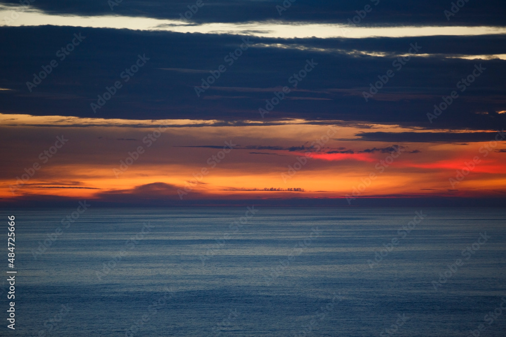 orange sunset clouds over the ocean