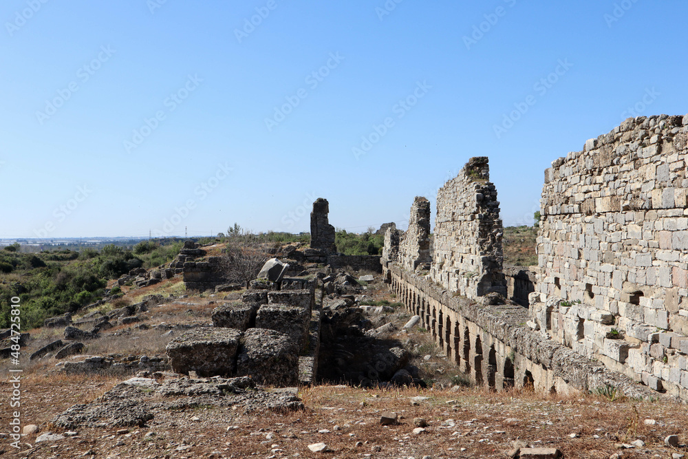 ruins of the ancient agora at archaeological site Aspendos in Turkey under clear blue spring sky