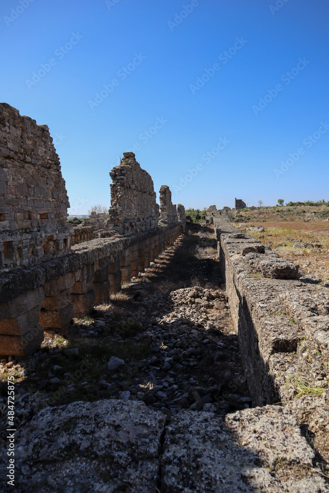 ruins of the ancient agora at archaeological site Aspendos in Turkey under clear blue spring sky