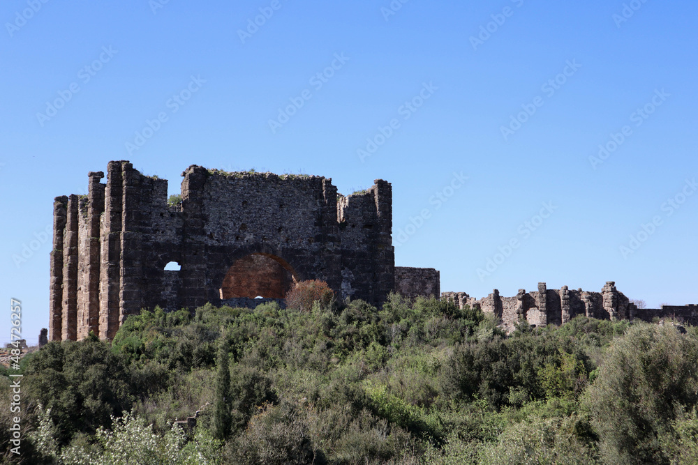 The Roman ruins of the Basilica at Aspendos ancient city in Turkey under clear blue spring sky