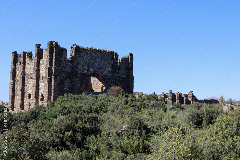 The Roman ruins of the Basilica at Aspendos ancient city in Turkey under clear blue spring sky