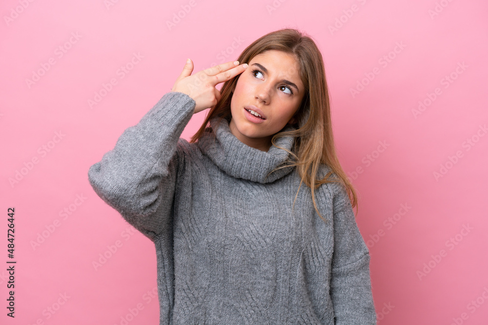 Young caucasian woman isolated on pink bakcground with problems making suicide gesture Young caucasian woman isolated on pink bakcground with problems making suicide gesture