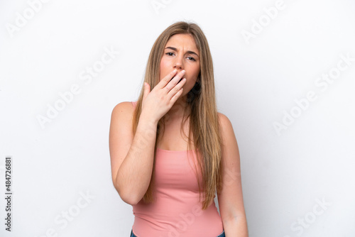 Young caucasian woman isolated on white bakcground yawning and covering wide open mouth with hand