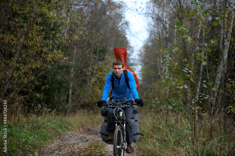 Naklejka premium Russian bicyclist in the autumn forest, Moscow Region