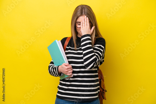 Young student woman isolated on yellow background background with tired and sick expression