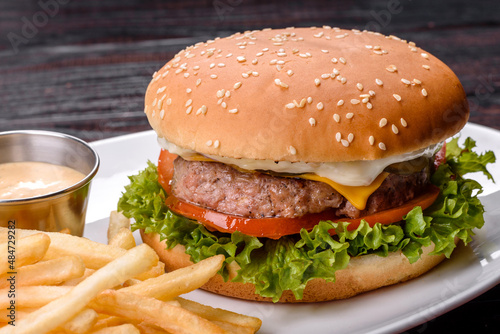 Close-up of home made tasty burger on a dark table