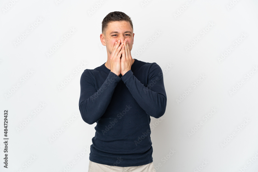 Young caucasian man isolated on white background happy and smiling covering mouth with hands Young caucasian man isolated on white background happy and smiling covering mouth with hands