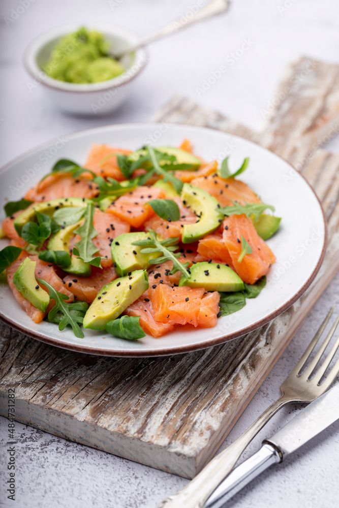 Fresh salmon salad with avocado, for keto and low carb diet. Rusty background, top view, copy space. Fresh salmon salad with avocado, for keto and low carb diet. Rusty background, top view, copy space.