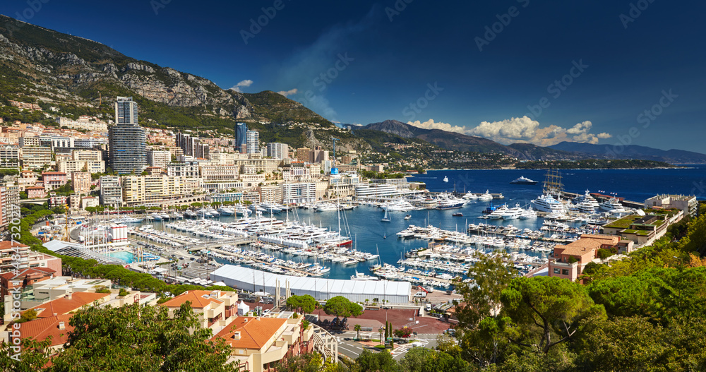 Aerial view of port Hercules in Monaco - Monte-Carlo at sunny day, a lot of yachts and boats are moored in marina, mediterranean sea