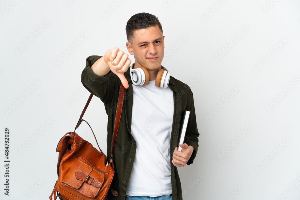 Young caucasian student man isolated on white background showing thumb down with negative expression Young caucasian student man isolated on white background showing thumb down with negative expression