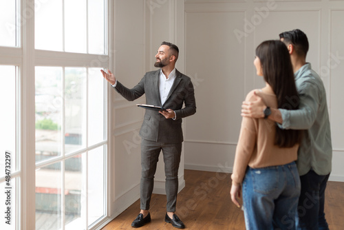 Real Estate Agent Showing Young Buyers New Property photo