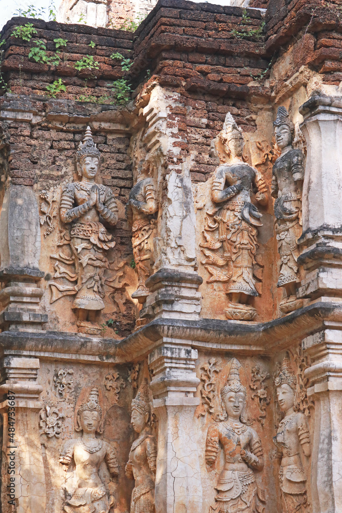 Ancient statue on temple wall,Thailand