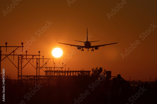 Airplane landing with the sun nearby © Ricard