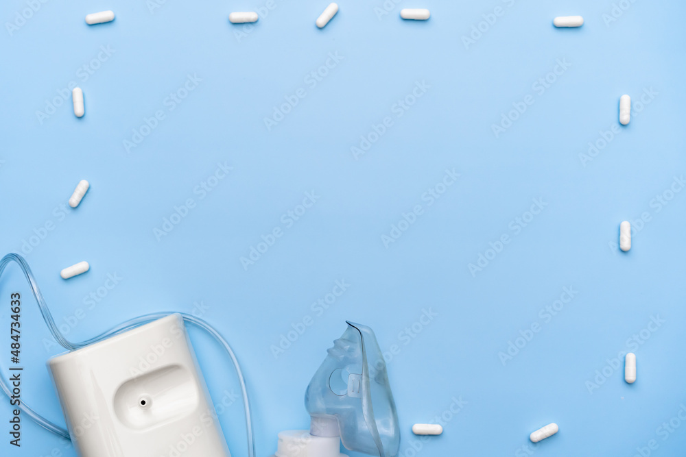 inhaler on a blue background, space for text, top view, flat lay inhaler on a blue background, space for text, top view, flat lay
