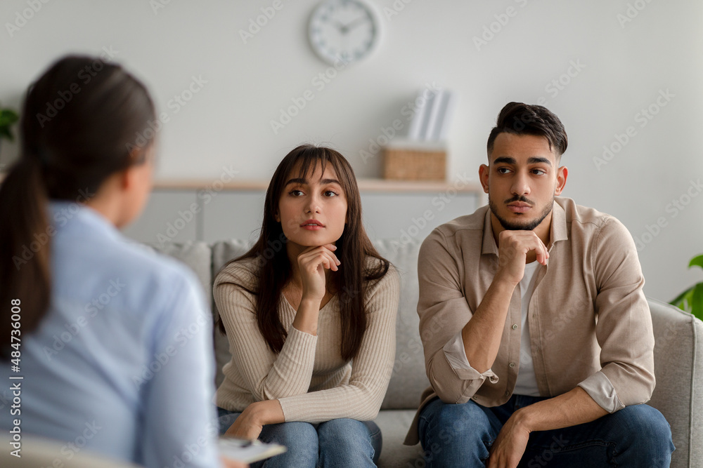 Marital psychotherapy. Sad arab spouses sitting at therapy session with psychologist, listening advices Marital psychotherapy. Sad arab spouses sitting at therapy session with psychologist, listening advices