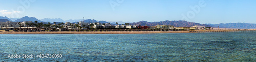 Marine landscape of a luxury hotel for family holidays in the Nabq bay. Resort with a tropical beach on the coast of the Red Sea in Sharm El Sheikh, Egypt.