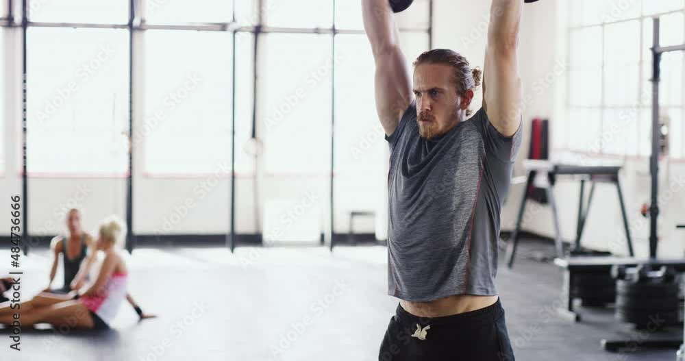 Power and perseverance. 4k video of a muscular young man working out with kettlebells in the gym. Power and perseverance. 4k video of a muscular young man working out with kettlebells in the gym.